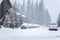 Mountain town street covered in deep fresh snow during a blizzard