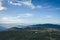 Mountain tracking. People in distance on blue sky background. Seasonal photo in cold tones