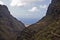 Mountain trail through the gorge of the oxamite mountain and the sea to the mysterious waterfall on the island of Tenerife,