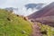 Mountain trail leading to white clouds and wonders