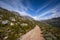 Mountain trail, mountain range and vista across the valley