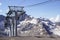 Mountain trailer funicular gray descends on the background of snow-capped peaks and mountain valley, mount Elbrus