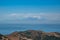 Mountain with trees in front of the sea and viewpoint to cloudy African continent silhouette on horizon, Tarifa SPAIN