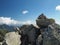 Mountain trek scenery cairn yellow marked path, stone pile