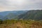 Mountain valley covered with forest and white mists at morning from flat angle