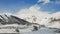 Mountain valley in Kazbegi region with small town covered with snow on clear day