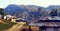 Mountain valley in mist at dawn .Rural area house mountain far away