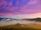 Mountain valley, an old house in the fog. Carpathians, Ukraine.