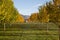 Mountain valley tree lined farm house in autumn