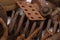 a mountain of various rusty metal construction parts on a white background. Selective focus