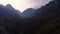 Mountain view of Alpine peaks and forest and sunset sky