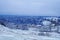 Mountain view covered with snow under a blue sky with white clouds