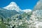 Mountain View of high snow capped Peak and Hiker walking