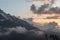 Mountain view of the snow capped peaks of Caucasus Mountains in clouds at sunset, landscape
