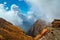 Mountain view with white curling clouds and a flying eagle