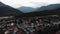 Mountain village with cottages surrounded by Alps in France. Drone flying in mountains valley. Commune Doussard drone shot view