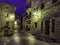 Mountain village street at night. Architecture of stone houses, balconies with flowers and illuminated alleys. Torla Ordesa.