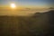 Mountain with village at sunrise on Dieng Plateau