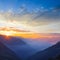 mountain walley in dense blue mist at the sunrise