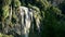 Mountain waterfall among greenery