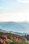 Mountain wilderness landscape, panorama hills mountain range covered with forest, warm autumn day October, blue haze on horizon