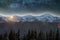 Mountain winter night panorama, Christmas landscape. Steep long ridge mountain peaks covered with snow and dense spruce forest