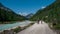 Mountainbiking along river Isar in the Karwendel mountains during blue sky day in summer, Austria