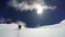 Mountaineer climbs snowfield on a sunny day