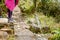 Mountaineer girl standing on the edge of a small bridge