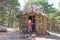 Mountaineer little child with trekking stick in ancient stone hut in Canencia forest