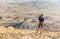 Mountaineer man tourist backpacker standing looking view desert