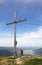 Mountaineer and mountain cross, beautiful view over lake tegernsee, bavaria, germany