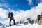 Mountaineer reaches the top of a snowy mountain