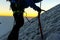 mountaineer silhouette at sunrise with ice ax in hand