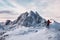 Mountaineer standing on Segla mountain with majestic snowy mount on winter at Senja island