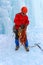 Mountaineer standing under the glacier is preparing a rope for climbing