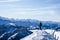 mountaineer at the summit against blue snow covered mountain layers. panoramic picture at the summit of the snowy mountain.