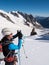 Mountaineer taking picture with a camera in the mountains.