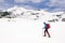 Mountaineer traversing an iced lake in Retezat Mountains..