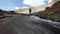 Mountaineer which descends beside a high mountain glacial stream