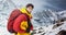 Mountaineer in winter clothes with hiking equipment against snowy landscape