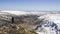 Mountaineer woman observes a huge U-shaped glacial valley and snowy mountains. Pena Trevinca, Tera River Valley