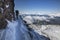 Mountaineering ascending to the top above the clouds in French Alps