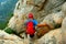 Mountaineering enthusiasts observe the downhill route at the cliff edge of the summit of Shaolin mountain in Songshan, China