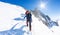 Mountaineers climb a snowy peak. In background the famous peak Dent du Geant in the Mont Blanc Massif, the highest european mounta