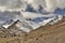 Mountaineers and donkeys carrying climbing equipment on a mountain path to the base camp of Stok Kangri peak at 5500m