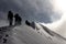 Mountaineers on a snowy mountain ridge on a alpine tour called Spaghetti Round in the European Alps, Monte Rosa Massif, Italy