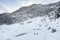 mountaineers walking through the snow in the alps