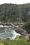 Mountainous Landscape with the beautiful beach and the famous Storms River Bridge at Tsitsikamma National Park in South Africa