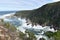 Mountainous Landscape with the beautiful beach and the famous Storms River Bridge at Tsitsikamma National Park in South Africa